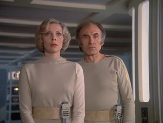 Barbara and Victor are standing together, shoulder to shoulder,  in a room on Moonbase Alpha. Victor looks quite concerned, while Barbara is thoroughly startled