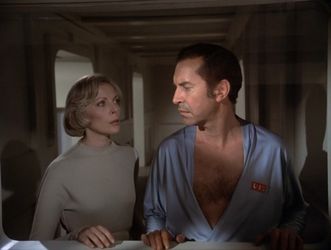 At the end of the episode, Barbara and Martin stand at a window. Martin is  wearing a skimpy robe, revealing an unnecessary amount of chest hair. He's  not making eye contact with Barbara, who is looking at him with concern.