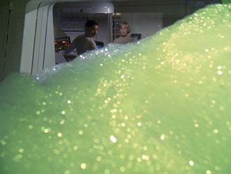 Barbara and Bob look out the infirmary window as it is engulfed by green foam.