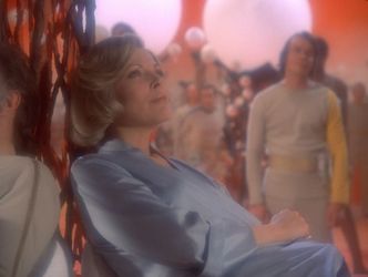 Barbara is sitting on the ground leaning against one of Piri's weird trees made of glass and wire. She looks thoroughly blissed out. Out of focus in the background are a few more blissed-out Alphans.